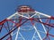 Detail of high voltage towers painted red on top of a mountain