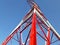 Detail of high voltage towers painted red on top of a mountain