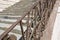 Detail of an historical old italian chiseled stone staircase with wrought iron railing and stone paving