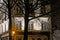 Detail  of a house with silhouette of a bare tree at night in Ghent