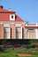 Detail of the house, windows, bricks, round baroque window, arched windows, historic style, architecture, garden, park, flowers,