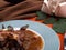 Detail of hunting stew and chocolate sauce on round plate