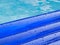 Detail of an inflatable pad floats in a swimming pool