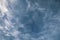 Detail of intense blue sky in broad daylight with fluffy white cirrus