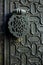 Detail of an islamic door knocker outside one of the main entrance gates to the Cathedral of Seville, Spain. Shallow DOF