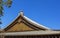 Detail on japanese temple roof against blue sky