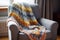 detail of a knit blanket on a quiet reading chair