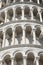 Detail of Leaning Tower of Pisa with white arches and columns in