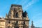 Detail of the left wing facade of Louvre Palace on a sunny summer day in Paris