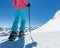 Detail of legs of young woman skier in beautiful Alpine landscape