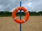 Detail of lifebuoy hanging on the blue slope on the sand beach in the place between Gdansk and Gdynia in Poland