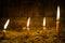 Detail Of Lit Candels Aligned In The Sand