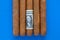 Detail of luxury Cuban cigars with US dollar