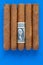 Detail of luxury Cuban cigars with US dollar