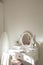 Detail of makeup dressing table with large mirror, diary and organizer. White and clean workstation in the master bedroom