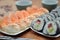 Detail of maki sushi rolls and nigiri sushi with salmon and shrimp japan food on the table with soy sauce and ginger