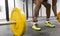 Detail of man practicing weightlifting in gym. Unrecognizable person