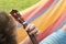 Detail of man relaxing on a hammock and playing ukulele