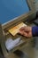 Detail of a man\\\'s hand extracting Argentine pesos from an ATM