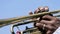 Detail of a man`s hands playing a trumpet. Action. Close-up of a black man`s hands playing the trumpet