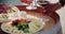 Detail of man and woman hands taking wine glasses.detail of table with finger food cheese appetizer at warm sunset.Hand