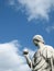 Detail of a marble sculpture of a man with a globe in SchÃ¶nbrunn in Vienna