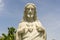 Detail of marble statue of Jesus Christ with heart in a temple and blue sky background in Danang, Vietnam