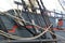 Detail of mast of ship. Detailed rigging with sails.