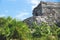 Detail of Maya ruins behind tropical plants, Tulum, Mexico