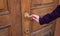 Detail of a metal handle on an old wooden door horizontal.