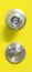 Detail of a metallic knob on yellow door , tainless steel round ball door knob