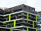 Detail of modern multi level residential building of dynamic shapes and masses with yellow glass decoration