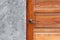 Detail of modern style metallic door handle on wooden door