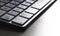 Detail of a modern white computer keyboard dirty and dusty on a white table