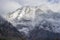 Detail of mountain face with rocks, snow and trees, in Styria region, Austria