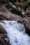 Detail of a mountain torrent of crystalline water flowing between rocks