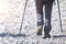 Detail of mountain walker on stony road with Nordic walking sticks