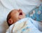 Detail of the mouth of a newborn while yawning. Selective focus on the mouth to accentuate the concept of the meaning of the yawn