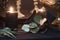 Detail of mysterious looking still life with handmade burning candles and stabilized dried leaves, craft art of wedding decoration