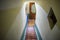 Detail of a narrow ladder stairs with carpet in beige color