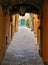 Detail of narrow street in old historic alley in the medieval City of Cortona near city of Arezzo in Tuscany, Italy