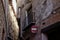 Detail of the narrow streets in the town of albarracin, teruel spain, with the texture of old brick walls and a traffic sign of