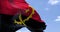 Detail of the national flag of Angola waving in the wind on a clear day