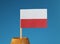 A detail on national flag of poland on wooden stick in wooden barrel