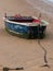 Detail of an old boat moored in the sand