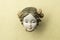 Detail of an old damaged porcelain chinese doll head