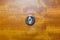 Detail of old lens peephole on wooden door background, for security in hotel.