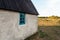 Detail of an old limestone house in Gotland cows in the background