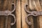 Detail of old oak wood gate with metal decoration