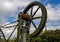 Detail of old steel cargo winch on harbour by tidal River Tamar in Devon